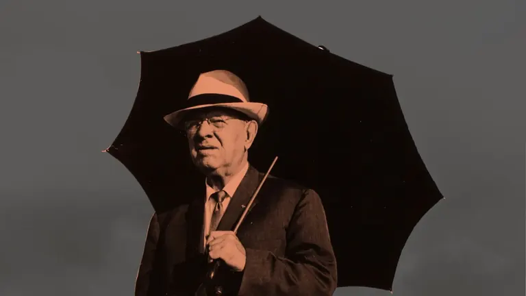 Pau Casals in a hat under an umbrella, image for Pau Casals a Puerto Rico at the Museu de la Música