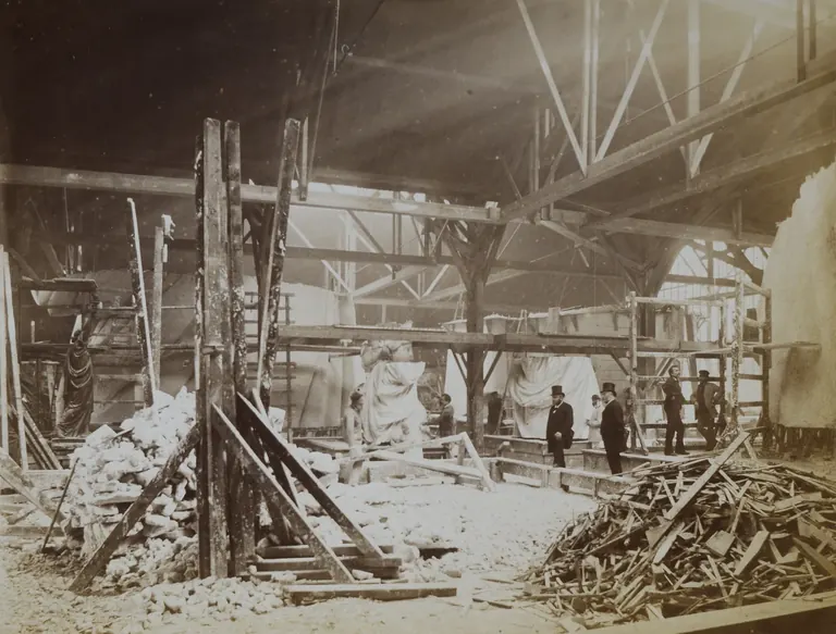 19th-century archive photograph of the Gaget workshop in Paris where the Statue of Liberty was built, with plaster models and scaffolding