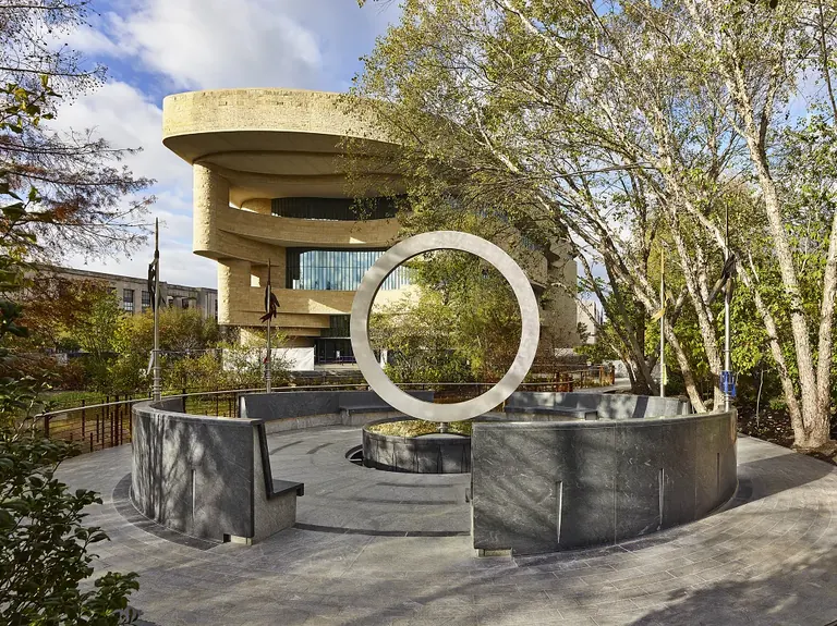 The National Native American Veterans Memorial, a stainless steel circle above a stone drum, on the museum grounds