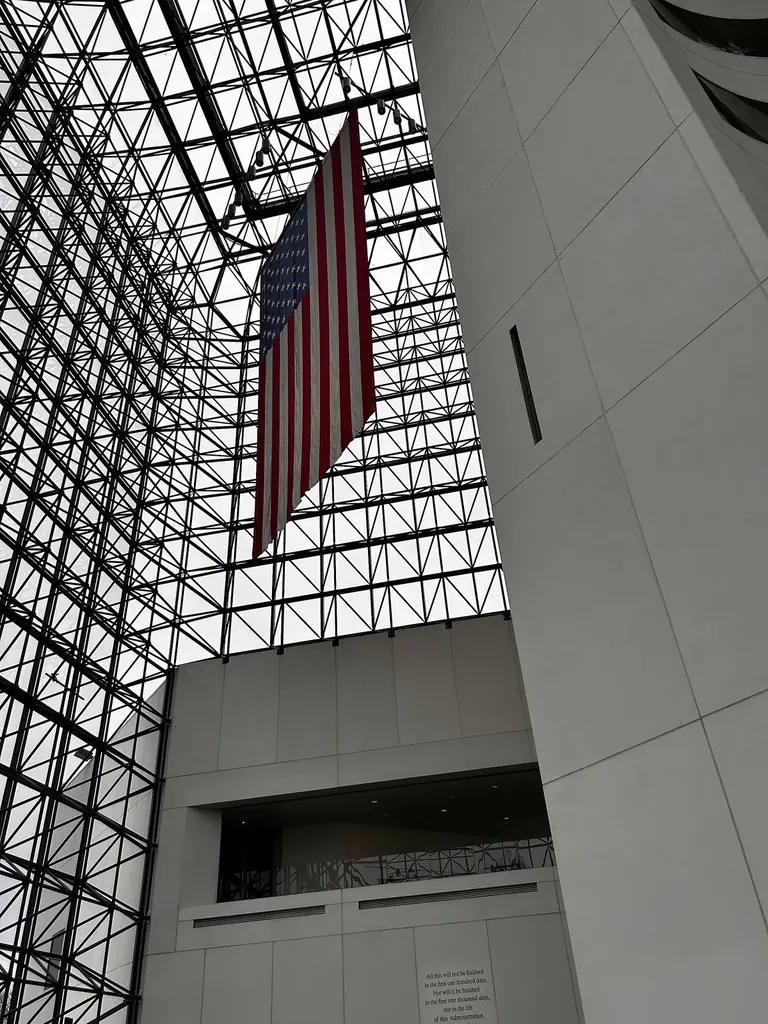 Interior of the glass Pavilion atrium at the John F. Kennedy Presidential Library and Museum, looking up through the steel lattice