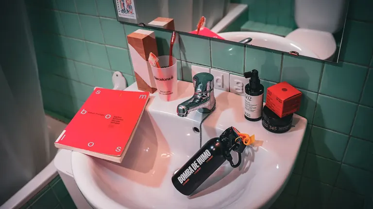 Award-winning branded products and a Frutiger book arranged on a bathroom sink, image for Premis ADG Laus 2026