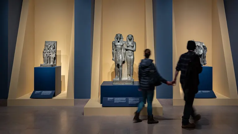 Visitors among Old Kingdom Egyptian sculpture in the Pyramid Age gallery at the Museum of Fine Arts, Boston