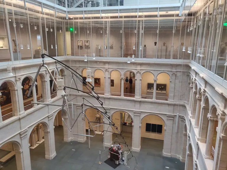 The Calderwood Courtyard at the Harvard Art Museums, its travertine arcades rising under Renzo Piano's glass roof