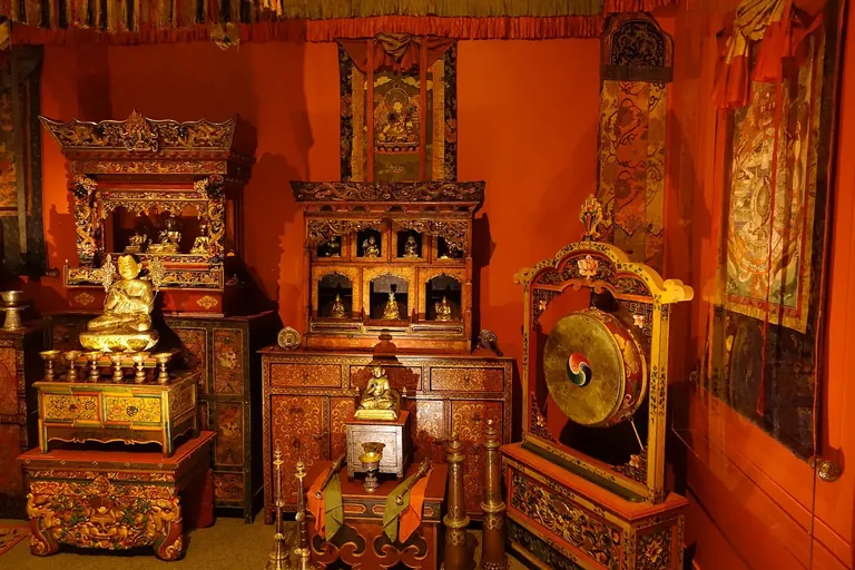 The Tibetan Buddhist Shrine Room in the Arthur M. Sackler Gallery, densely arrayed with gilt bronze figures, painted thangkas and ritual objects from the Alice S. Kandell Collection