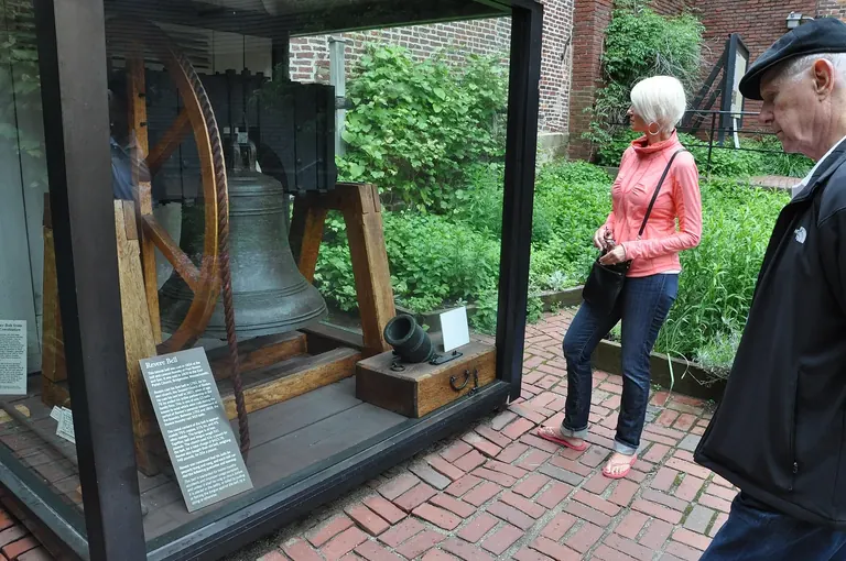 Bronze bell cast at the Paul Revere and Sons foundry, hanging in a wooden frame in the courtyard of the Paul Revere House