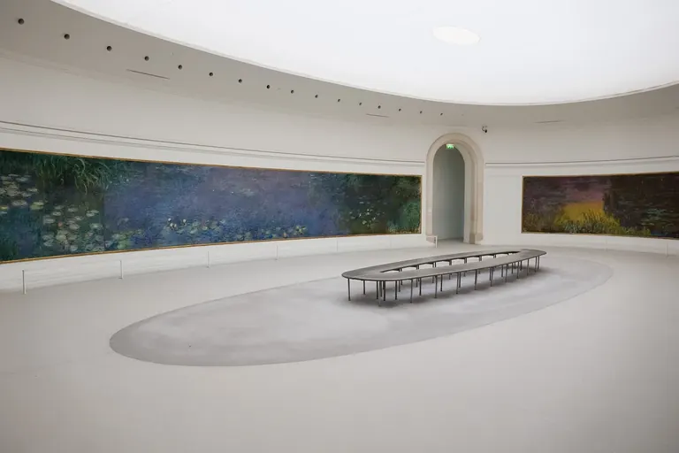 Claude Monet's Water Lilies displayed in an oval room at the Musée de l'Orangerie