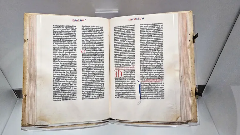 The Library of Congress copy of the Gutenberg Bible open in its display case in the Great Hall of the Thomas Jefferson Building