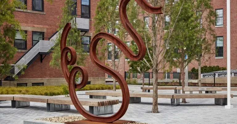 Matt Johnson's Untitled (Swan), a bent length of train track shaped into a swan, installed on the MIT campus