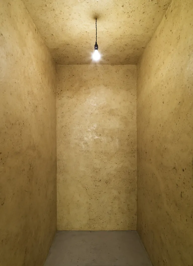 Wolfgang Laib's Wax Room at The Phillips Collection, a small chamber lined with beeswax and lit by a single bulb