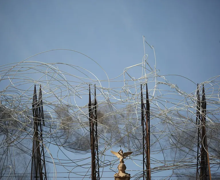 Antoni Tàpies's wire sculpture Núvol i cadira against a blue sky above the museum