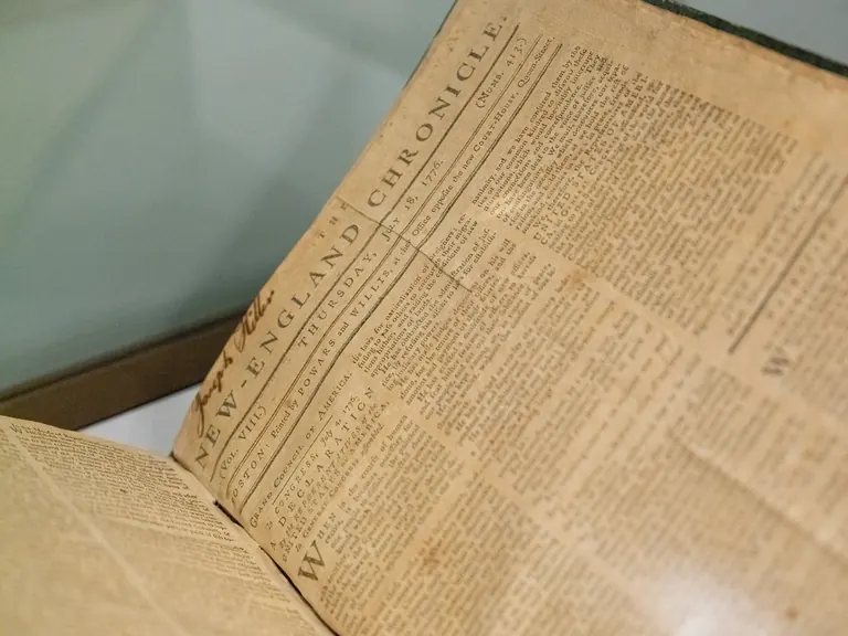 Display cases of rare books and printed material in the Imagined Nation installation at the Boston Athenæum