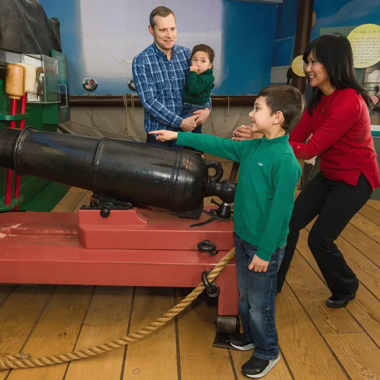 A family at the gun deck cannon in All Hands on Deck: A Sailor's Life in 1812