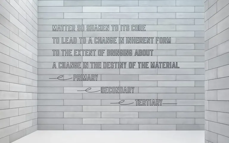 Lawrence Weiner's text installation on the concrete-block wall of the Pavilions entry at Glenstone
