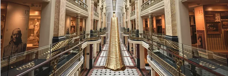 Glass cases of densely displayed artworks in the Luce Foundation Center for American Art