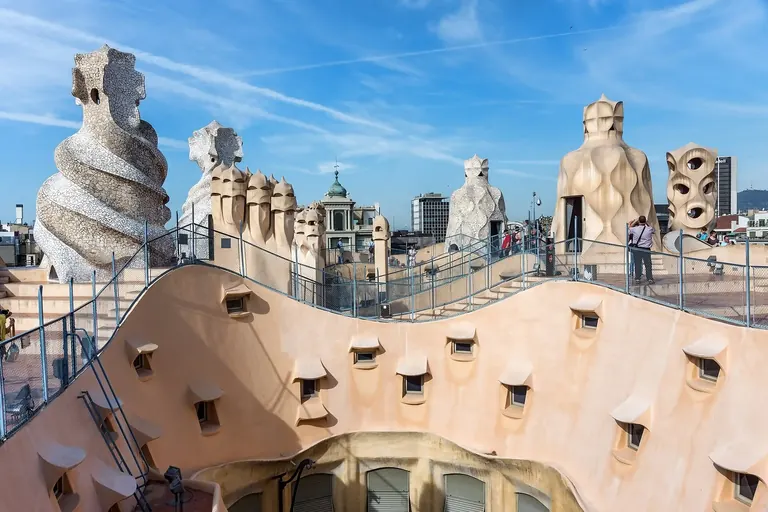 Sculptural chimneys and ventilation towers on the rooftop of Casa Milà