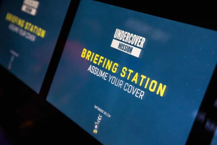 Visitors using an Undercover Mission digital interactive at the International Spy Museum