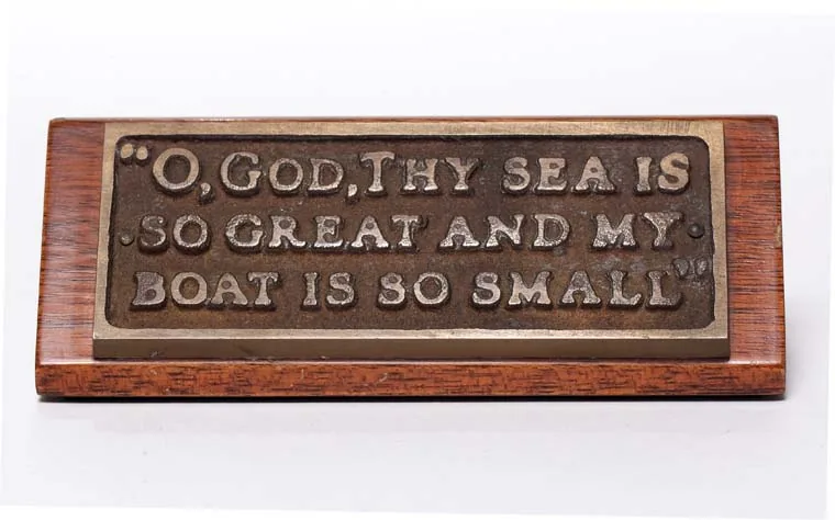 The Breton Fisherman's Prayer plaque that President Kennedy kept on his Oval Office desk, reading 'Oh God thy sea is so great and my boat is so small'