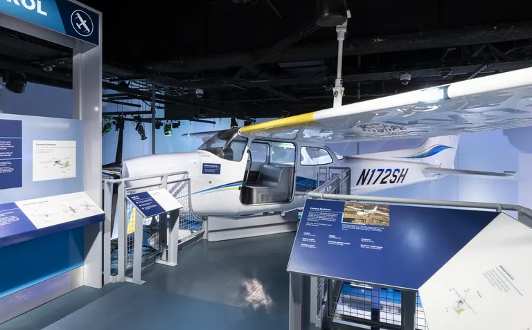 A small white Cessna Skyhawk aircraft in the gallery that visitors can climb into and sit in the cockpit