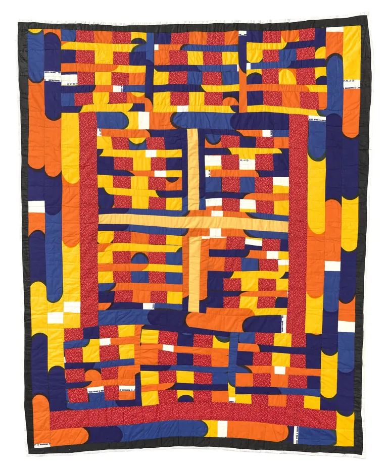 A vibrant, hand-quilted cotton textile features a combination of blue, orange, yellow, and red patchwork.