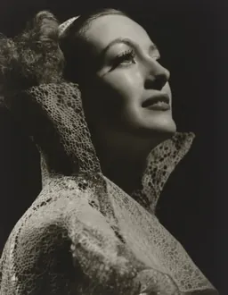 Black-and-white George Hurrell portrait of Joan Crawford, chin lifted, in dramatic studio lighting