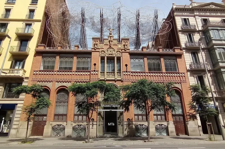 Red-brick Modernista facade of the Museu Tàpies on Carrer d'Aragó, topped by Antoni Tàpies's wire sculpture Cloud and Chair