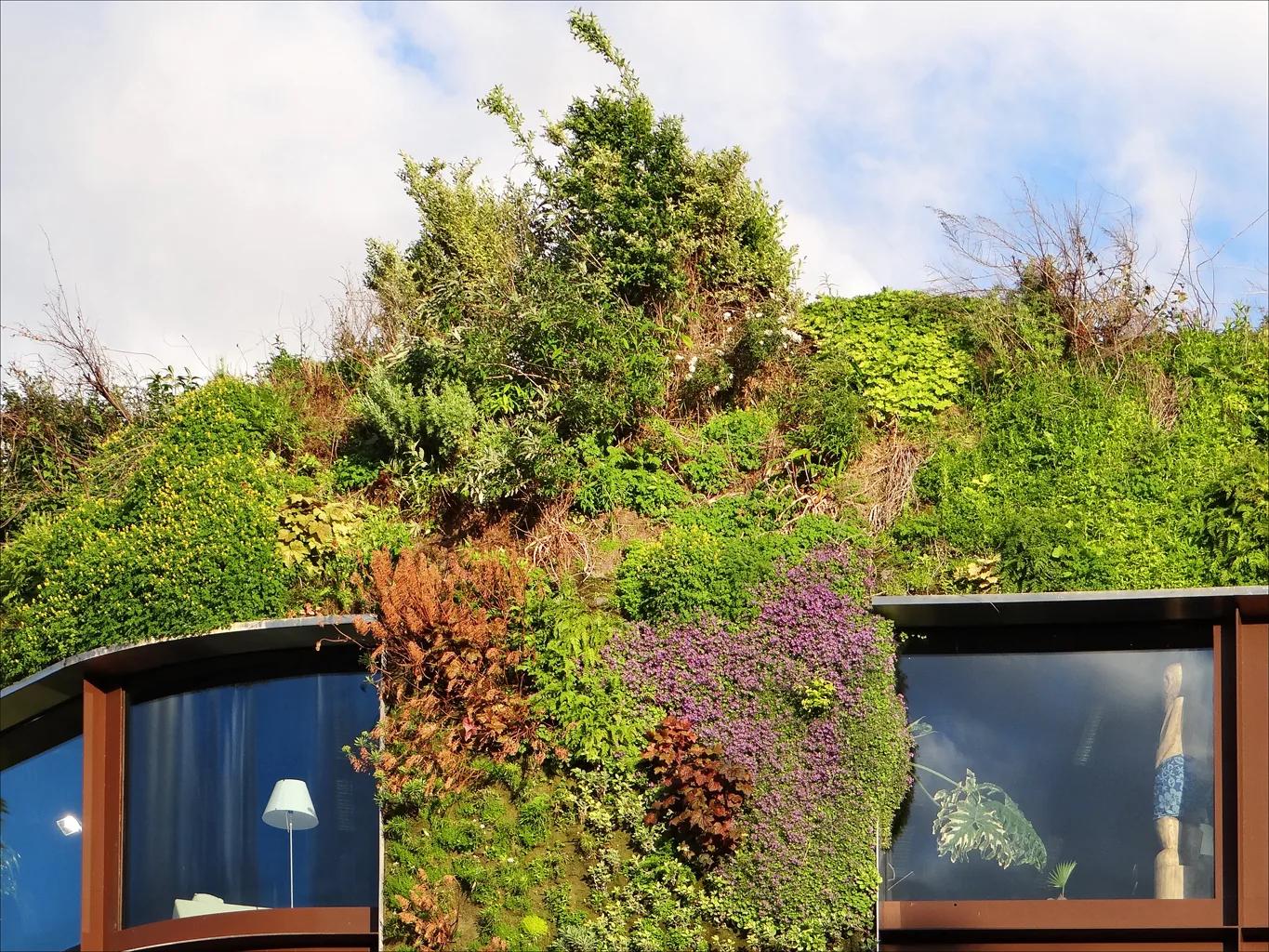 The living green wall and glass facade of the Musee du quai Branly - Jacques Chirac in Paris