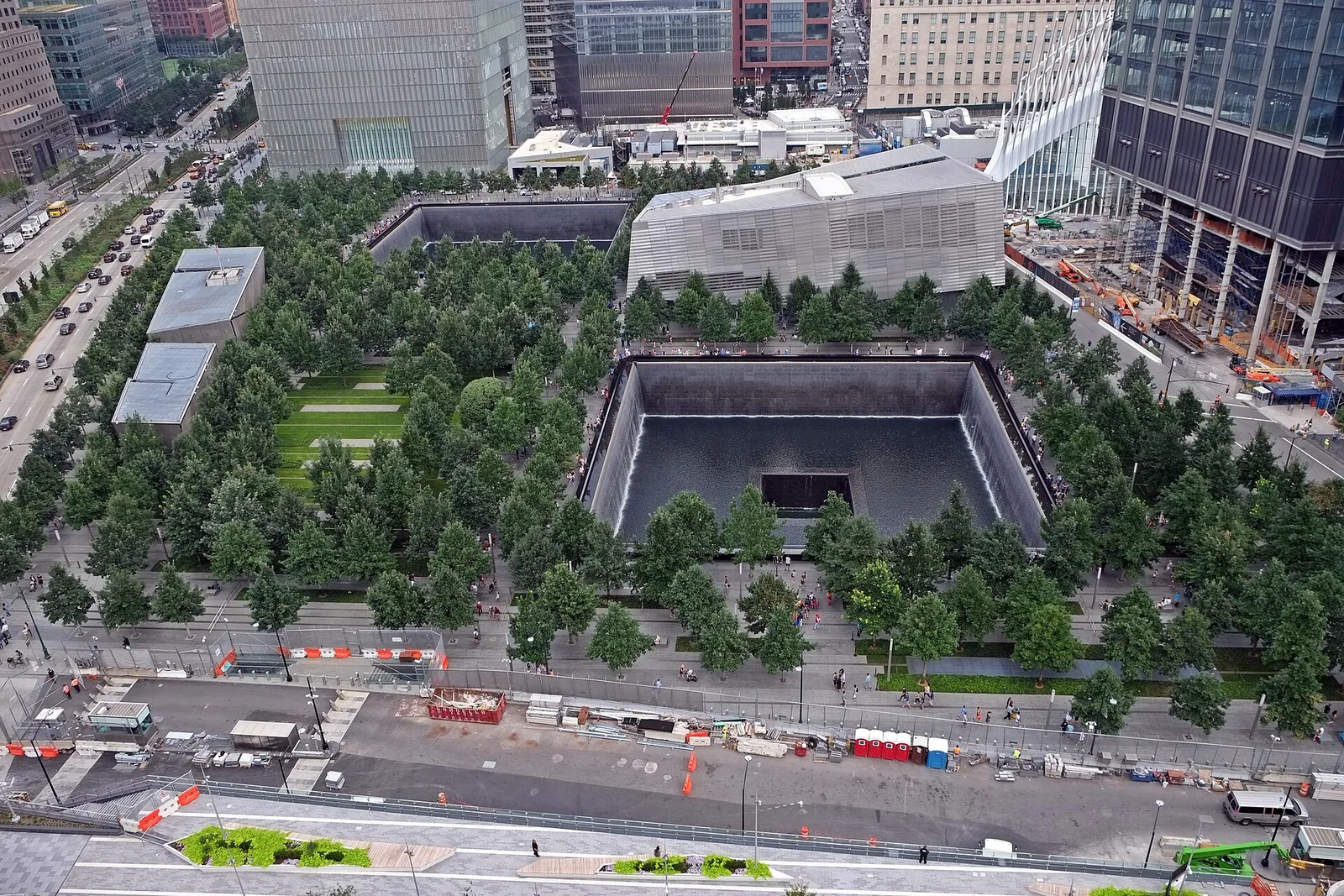 Exterior of the National September 11 Memorial & Museum at the World Trade Center site, with a reflecting pool in the foreground