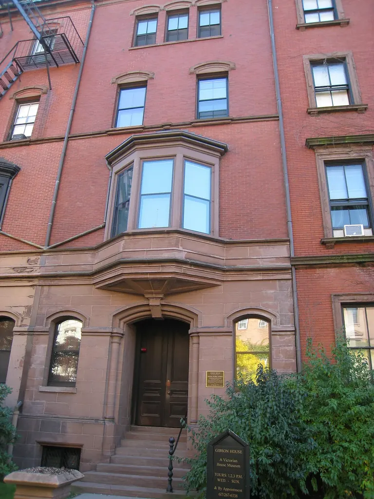 Brownstone and red brick front facade of the Gibson House Museum at 137 Beacon Street in Boston's Back Bay