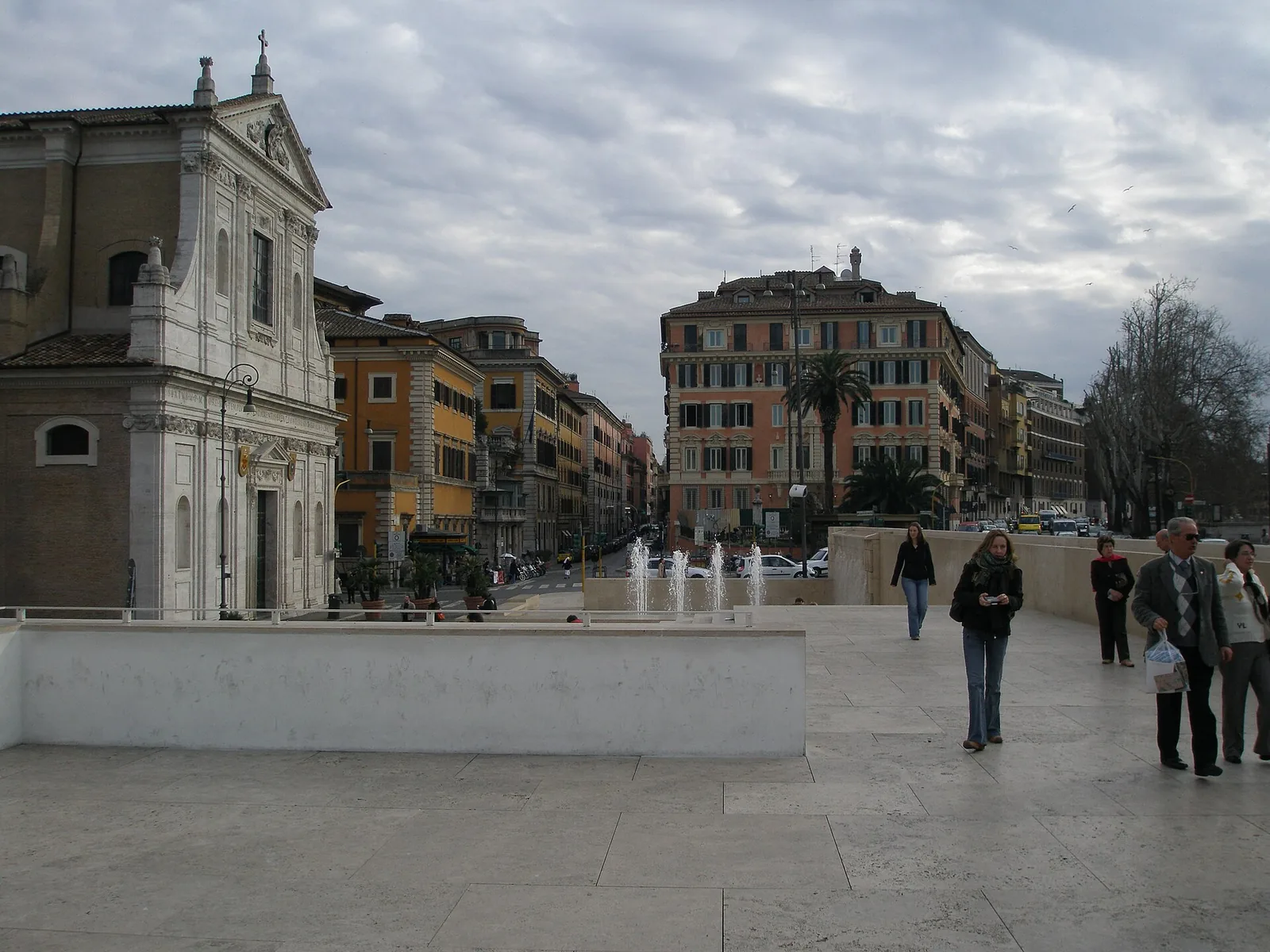 The white glass-and-travertine Ara Pacis museum building designed by Richard Meier, with fountain, beside the Tiber in Rome