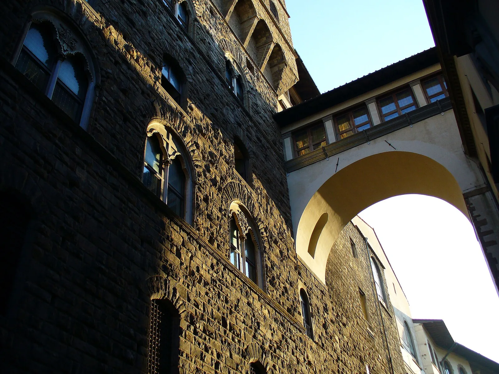 The Vasari Corridor, an elevated enclosed passageway in Florence, seen from outside showing its arched structure running above the street