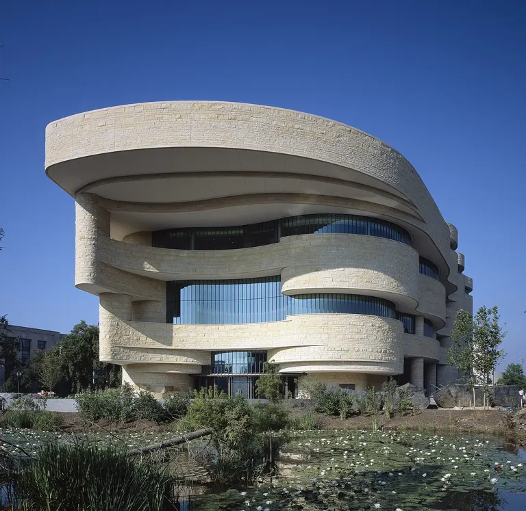 The curved Kasota limestone exterior of the National Museum of the American Indian on the National Mall in Washington, DC