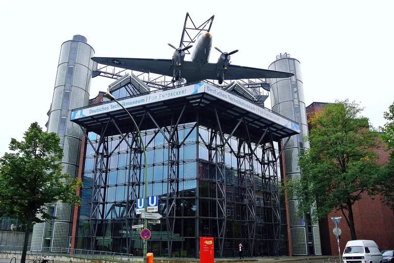 Glass facade of the Deutsches Technikmuseum in Kreuzberg with a C-47 'raisin bomber' mounted on the roof