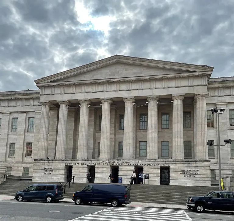 The Greek Revival portico and columned facade of the Old Patent Office Building, home of the Smithsonian American Art Museum in Washington, DC