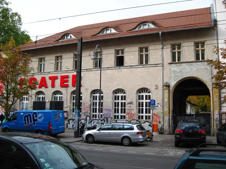 Street front of the Prater at Kastanienallee 7 in Prenzlauer Berg, with its red PRATER lettering and arched gateway to the garden
