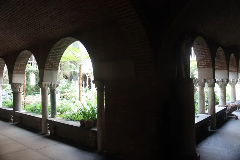 The glass-roofed central courtyard of the Isabella Stewart Gardner Museum, planted with ferns and palms and framed by Venetian Gothic arcades
