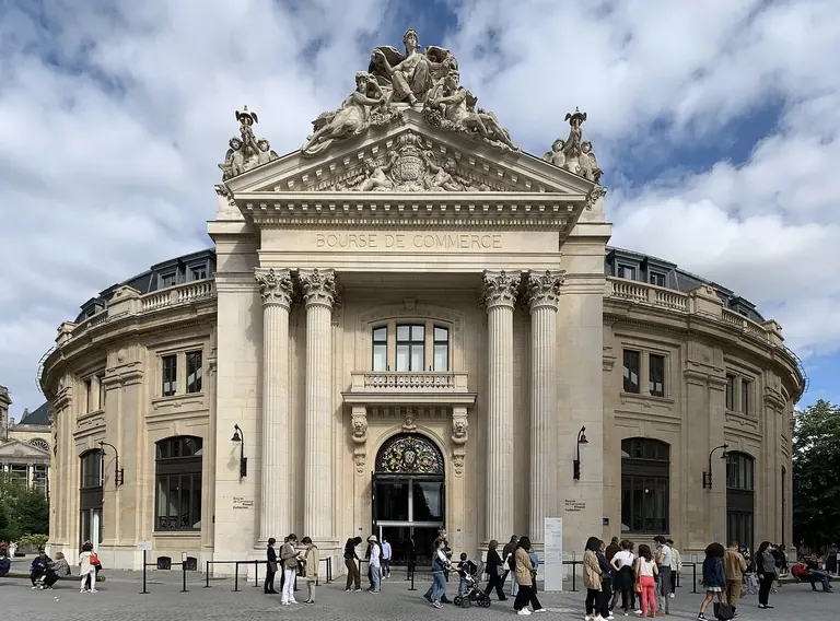 Exterior of the Bourse de Commerce, a circular 18th-century building with a copper-and-glass dome in central Paris