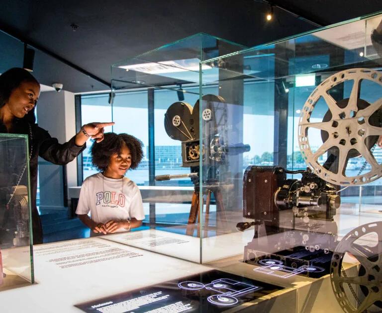 Display tables of historic film equipment at Eye Filmmuseum