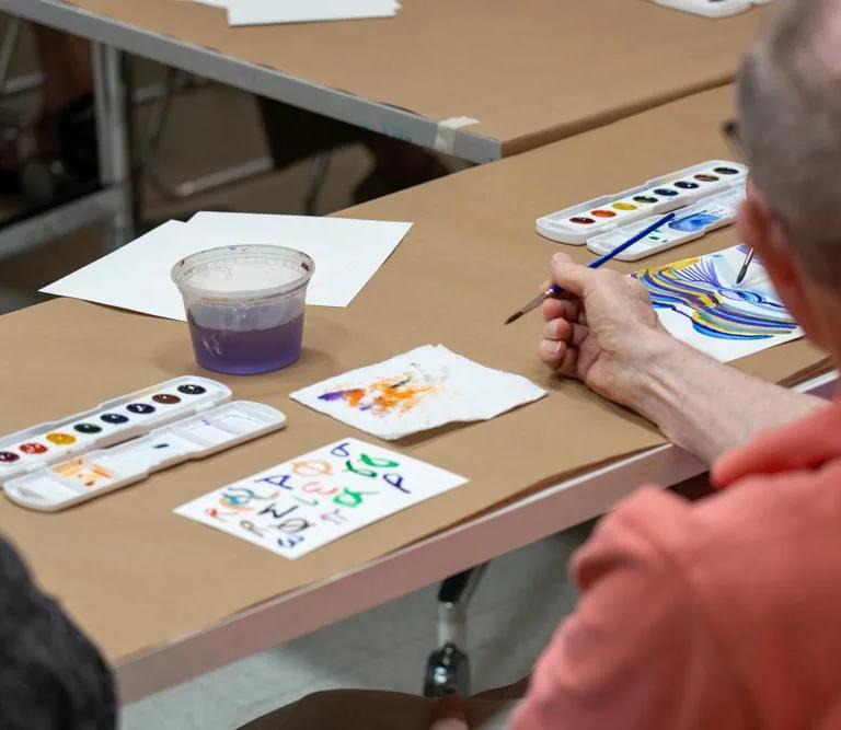 Participants in The Phillips Collection's Reframing Care programme making artwork together