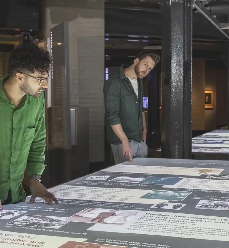 Visitors exploring the interactive Lifeline timeline display at the Churchill Museum