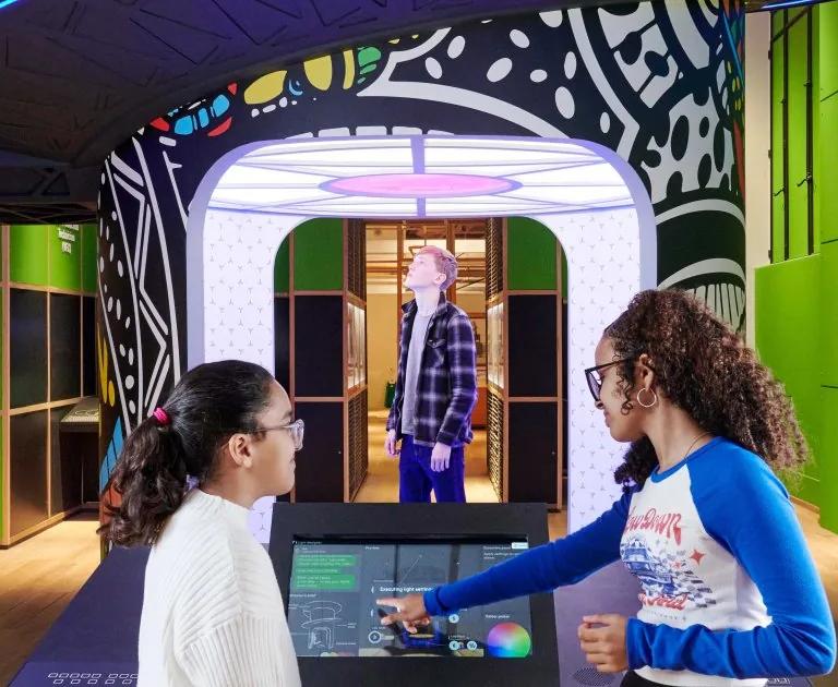 Visitors try the lighting technician interactive at Technicians: The David Sainsbury Gallery