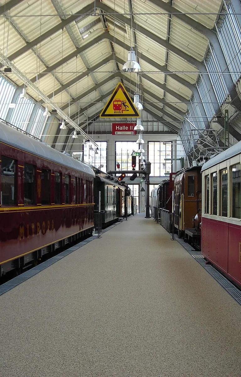 Interior of Halle II at the Verkehrszentrum, showing historic travel vehicles