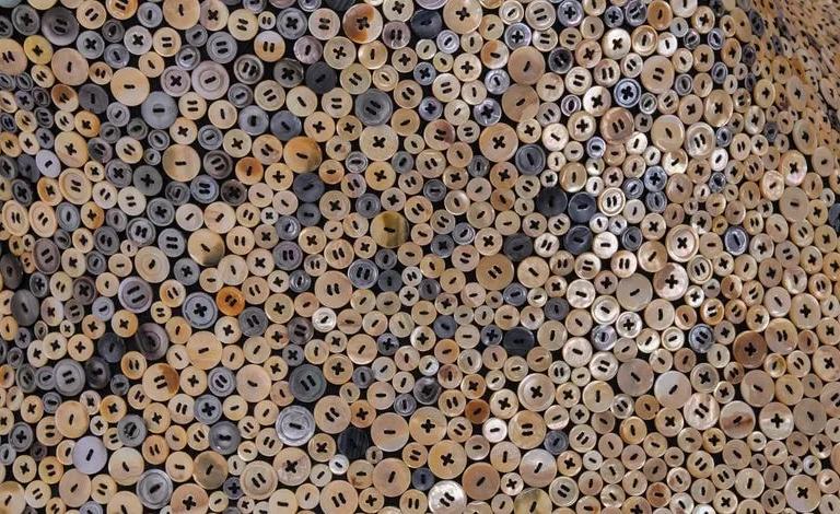 Detail of hand-sewn mother-of-pearl buttons from Nick Cave's Louder Still, 2025