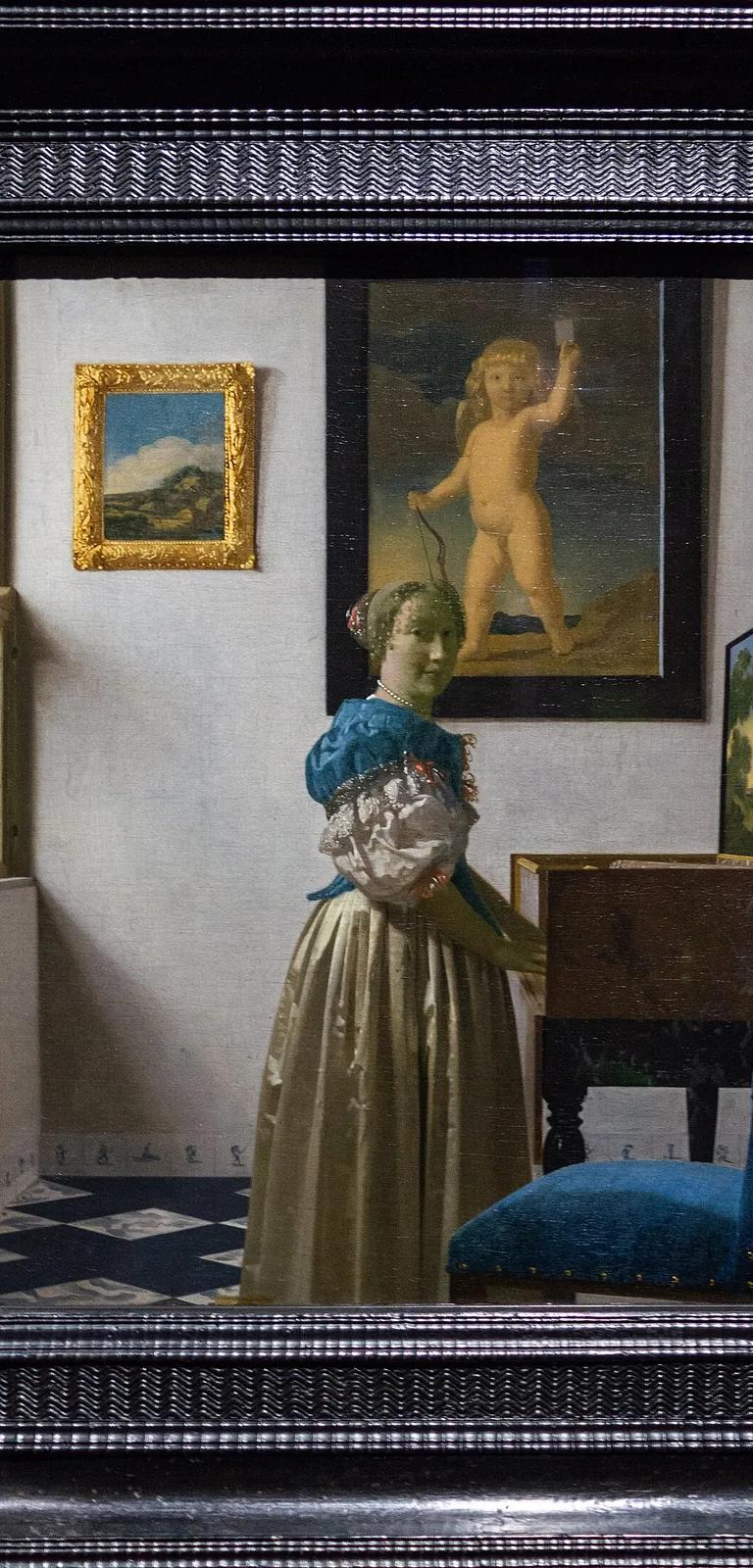 Young Woman Standing at a Virginal by Johannes Vermeer