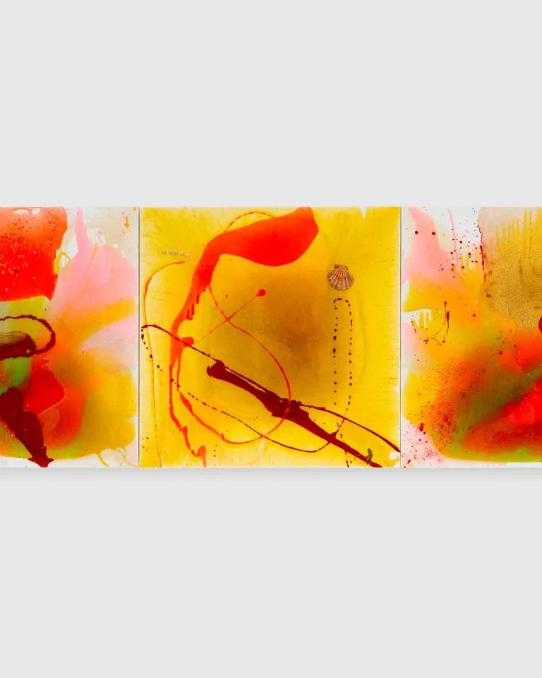 Triptych by Helen Marden composed of three white canvases with pools of orange, yellow, green, and pink resin and a seashell affixed to the center canvas