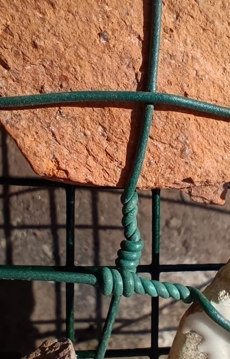 A rock with a green net in front of it
