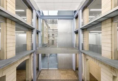 Interior view of the OMA-designed tower of motorized exhibition platforms at Lafayette Anticipations