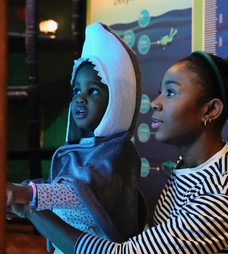 A child exploring the immersive Voyage to the Deep underwater adventure exhibition