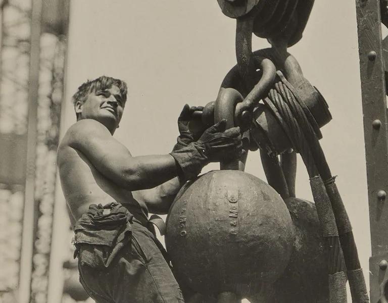 Lewis Hine photograph of a worker riding a wrecking ball high above the city