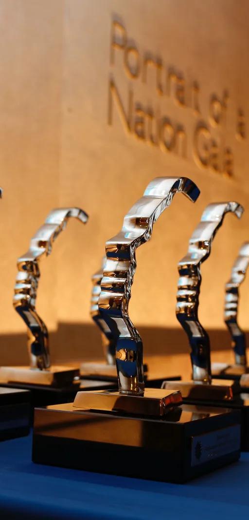 Gold Portrait of a Nation award trophies shaped as a face in profile