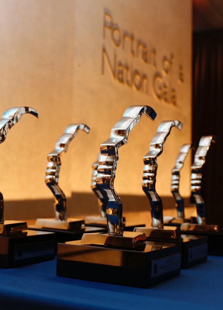 Gold Portrait of a Nation award trophies shaped as a face in profile